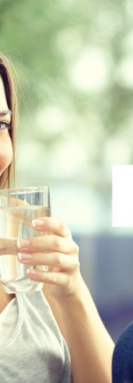 Girl drinking water at home